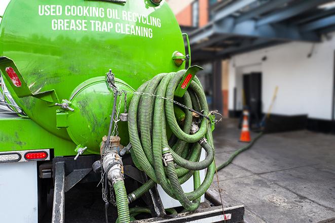 a grease trap pumping truck at a restaurant in Charlestown MA